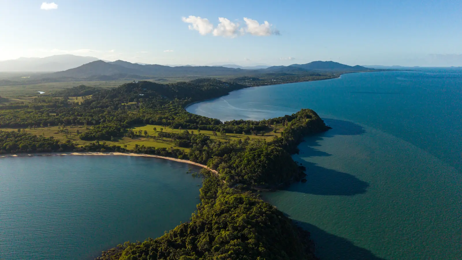The Point at South Mission Beach from the air, a bay either side and the range behind