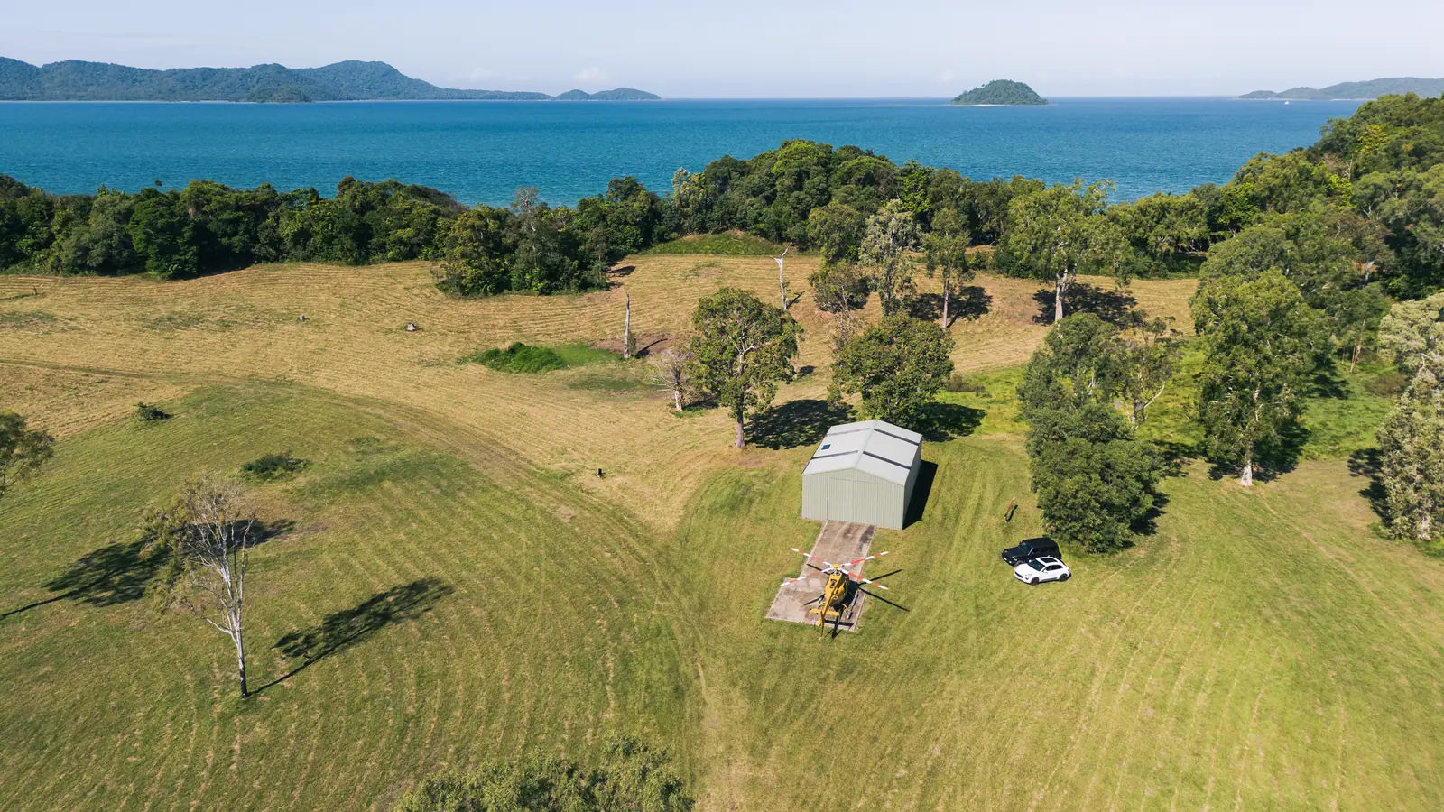 The shed and the helicopter pad from behind, the crest and the islands beyond.